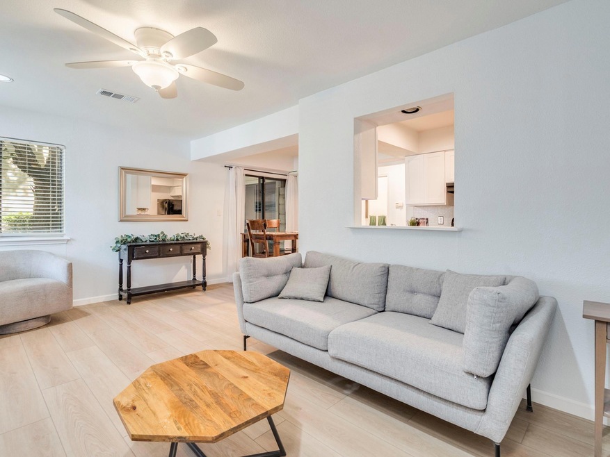 Living room with light wood finished floors, a ce