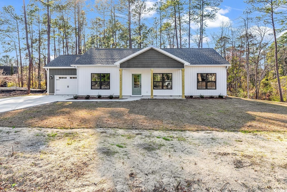 Modern farmhouse with concrete driveway, roof with