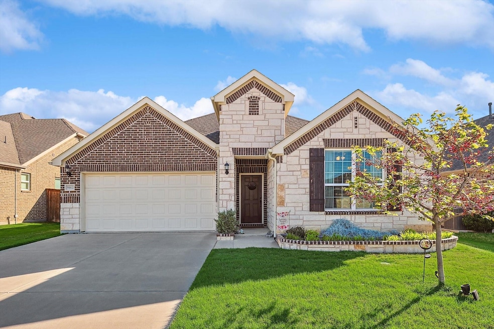View of front of home with a front lawn and a gara