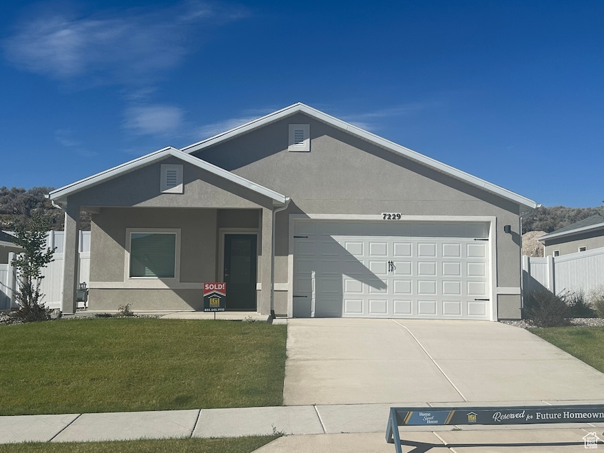 Ranch-style house featuring stucco siding, driveway, and a garage