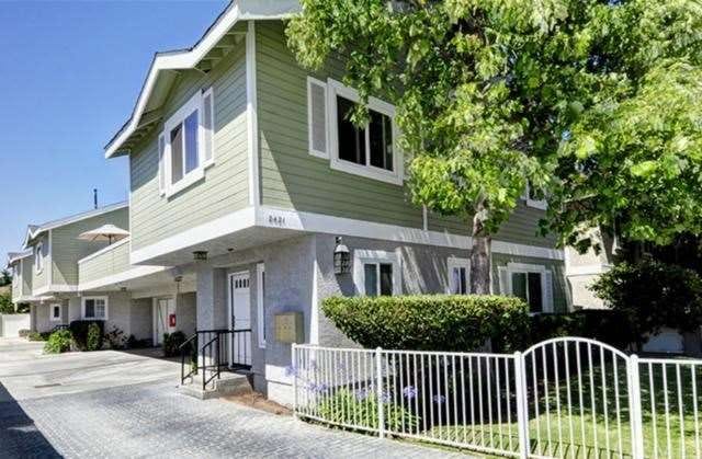 Beautiful exterior with front yard and mature tree