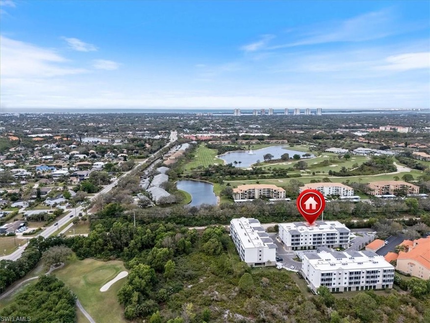Aerial view featuring a water view and a view of c