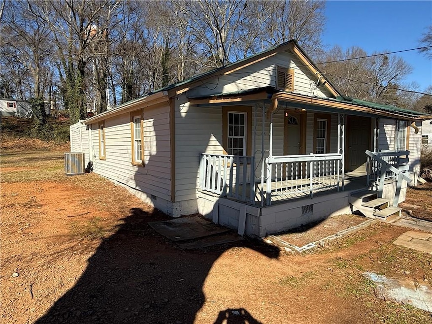 View of front of house featuring cooling unit and 
