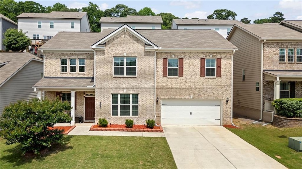 View of front of home with brick siding, driveway,