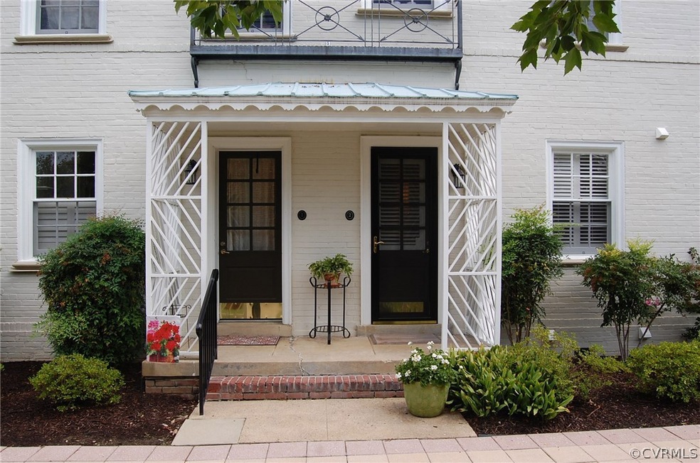 Charming front porch entrance with copper roof.