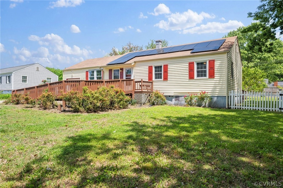 View of front of property with solar panels, a woo