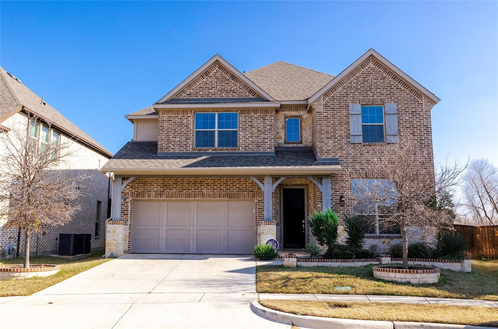 View of front of home with a garage and cooling unit
