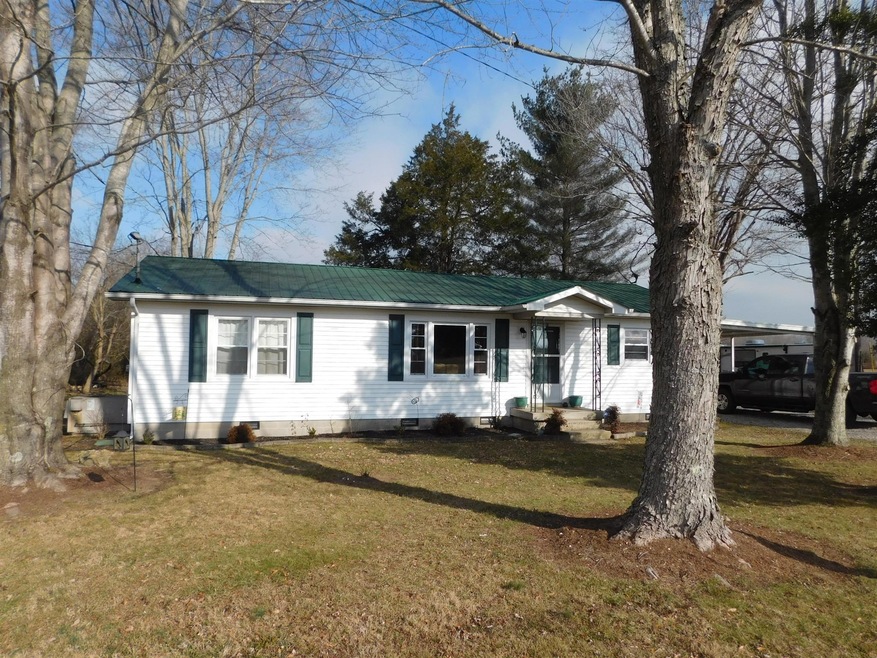Pretty little home on almost 5 unrestricted acres with pond
