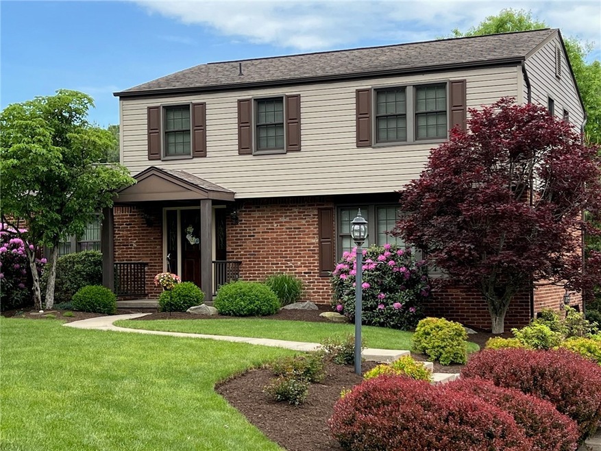 WELL LANDSCAPED TWO STORY BRICK AND VINYL HOME WIT