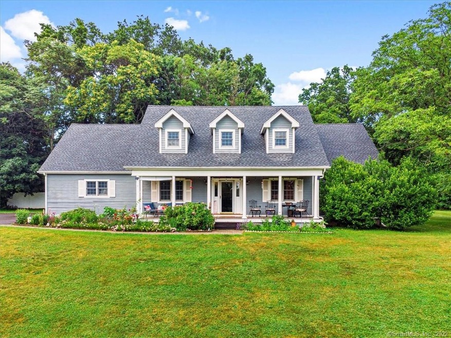 WELCOME HOME... lovely Cape Cod style home set back on a .84-acre interior lot offering a private setting.