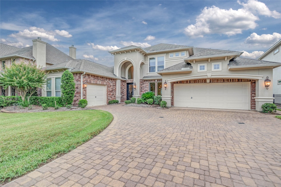 Beautiful and well maintained custom home w/ brick paver driveway and 3 car garage