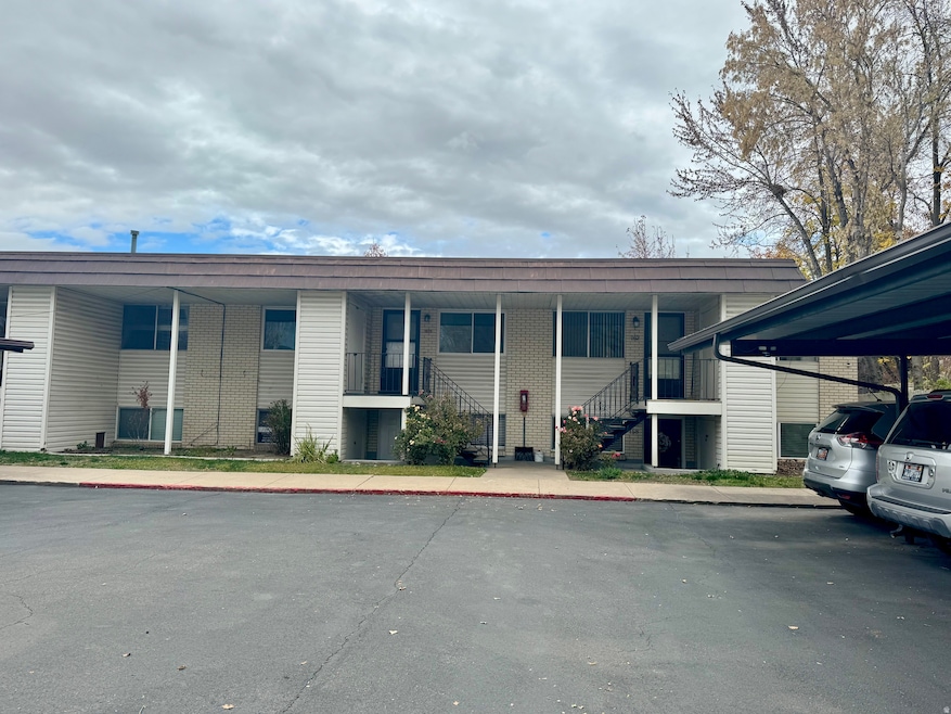 View of building exterior with stairway and a parking lot