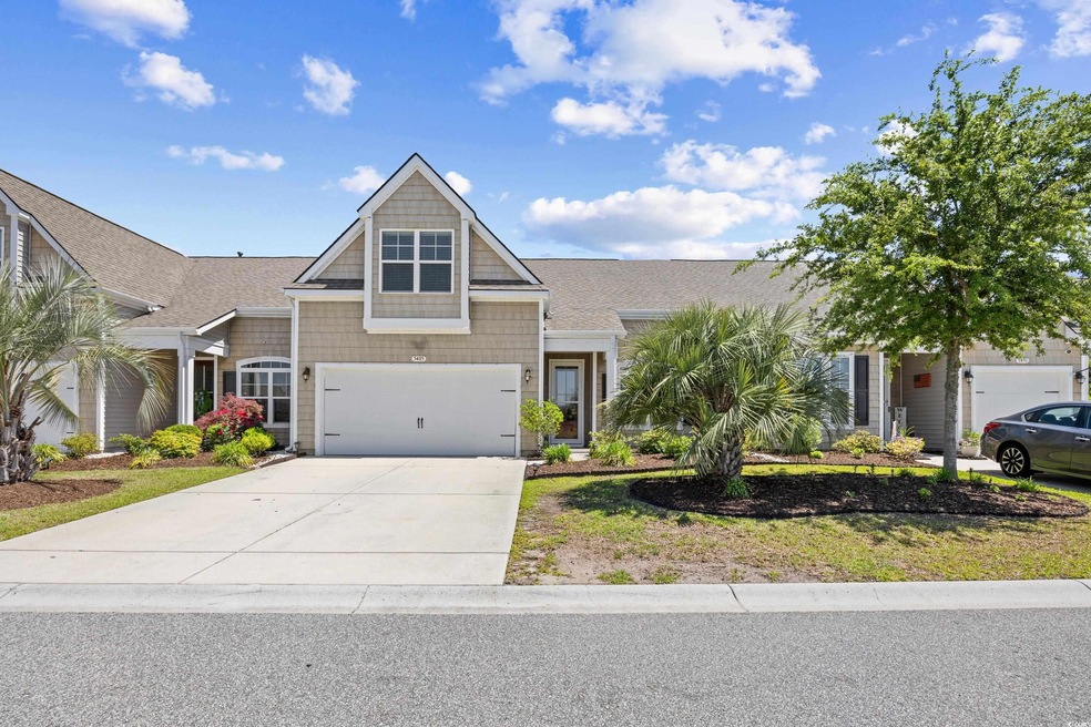 Craftsman-style house featuring a garage and concr