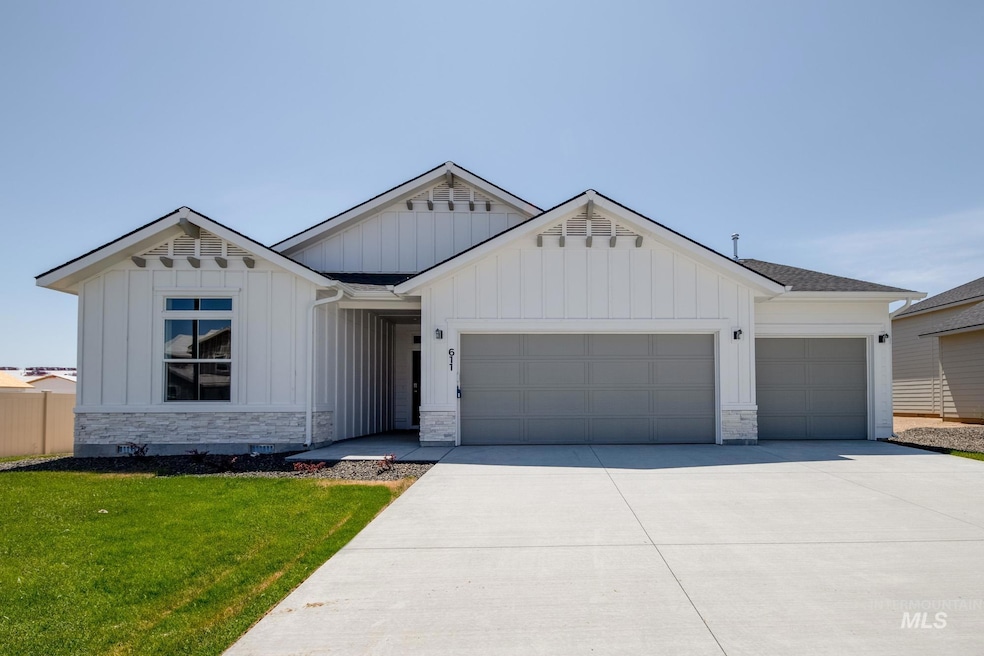 Modern farmhouse style home featuring a garage, board and batten siding, concrete driveway, and stone siding
