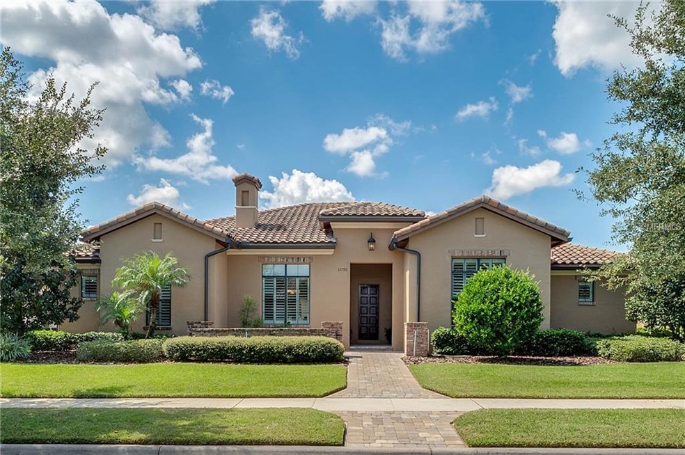 Grand entrance with beautiful pavers and lush land
