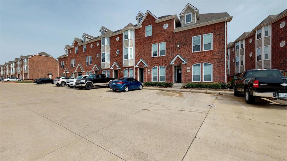 View of property with uncovered parking