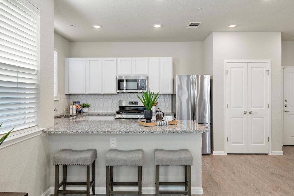 Kitchen with stainless steel appliances, a penins