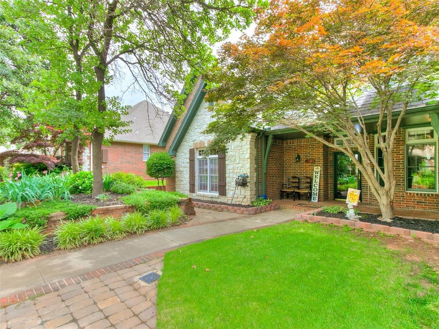 View of front of house with stone siding, brick siding, and a front yard