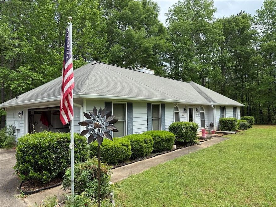 Ranch-style house with a chimney, a front yard, ro