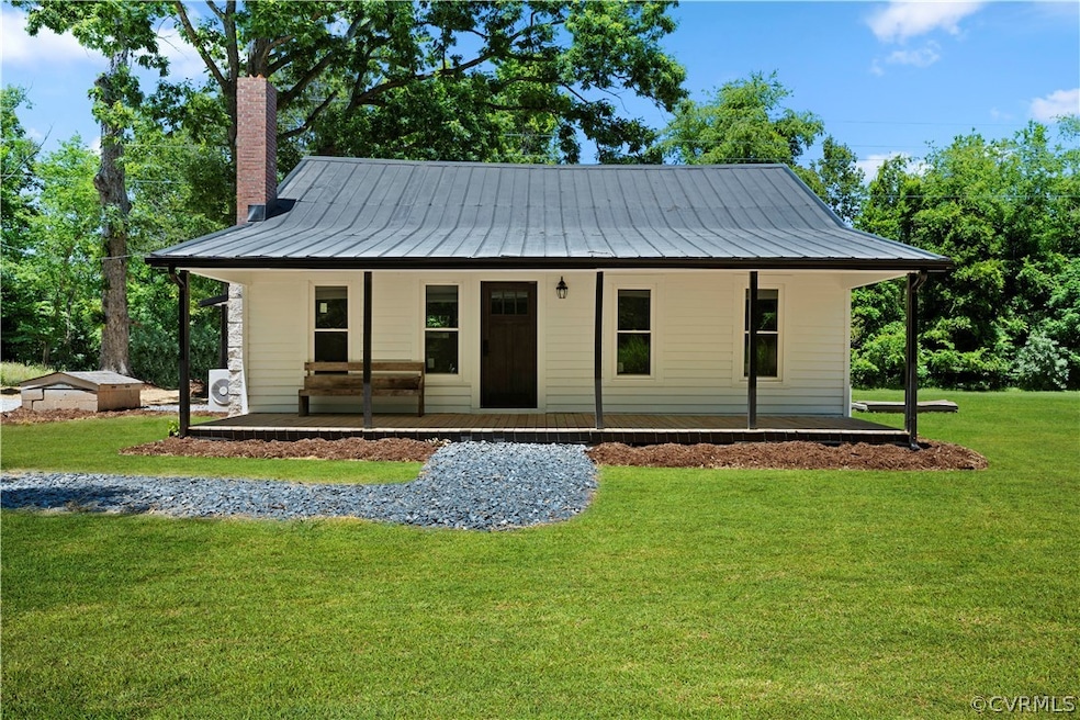 View of front of home featuring a front lawn and covered porch