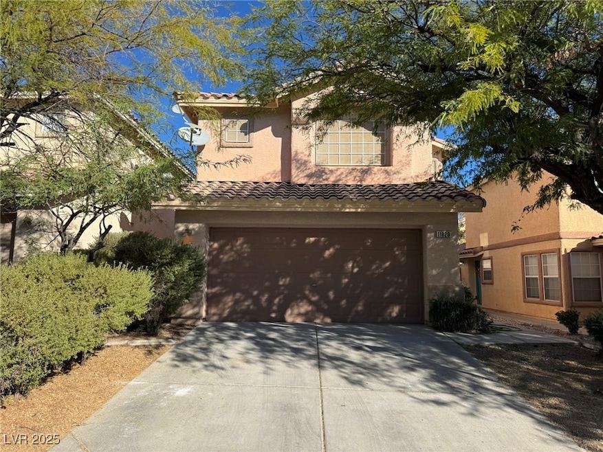 Mediterranean / spanish-style home featuring a garage, a tile roof, driveway, and stucco siding
