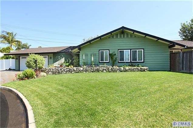 Elegant curb appeal with plush grass and blooming 