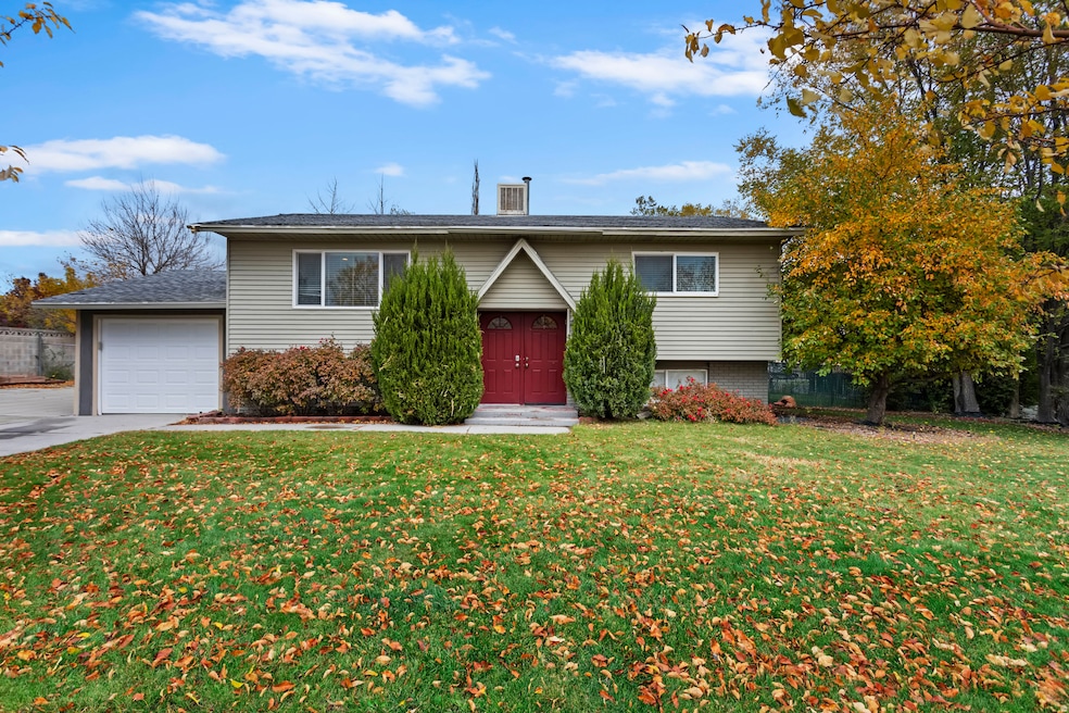 Bi-level home with concrete driveway and an attached garage ~ homes faces south