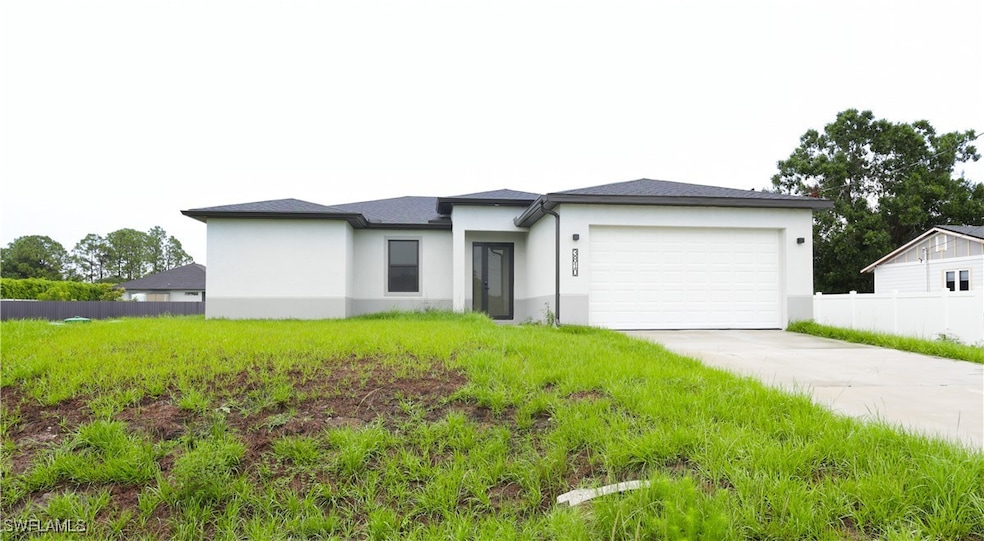 Prairie-style home with a garage, stucco siding, a