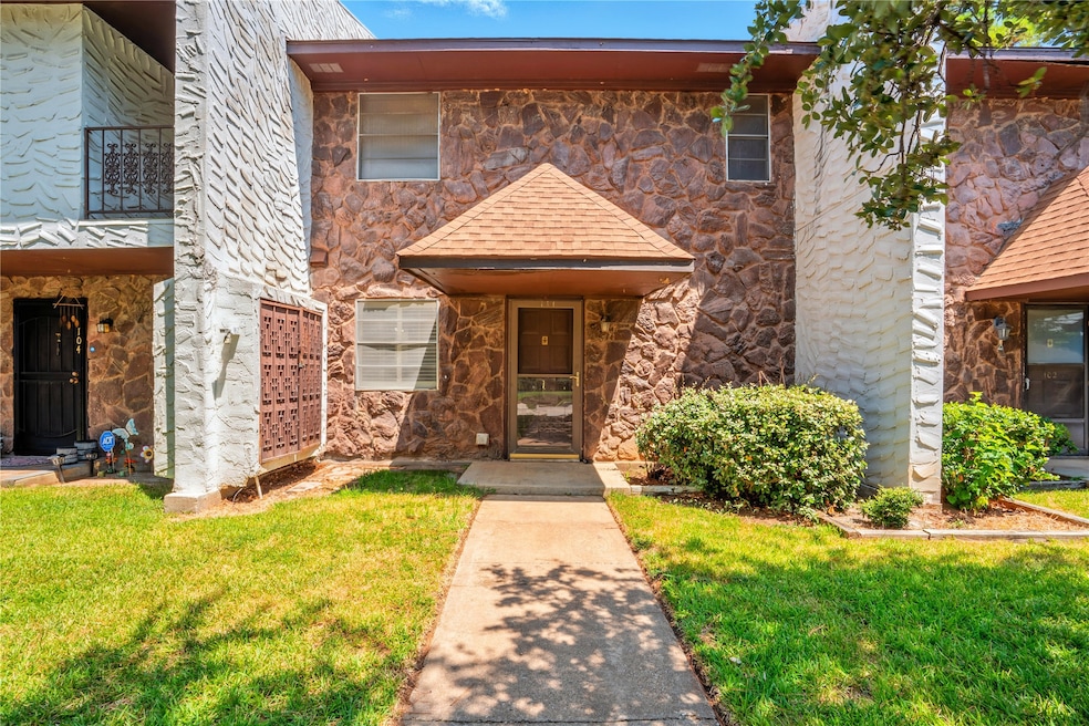View of front of house with stone siding and a front lawn