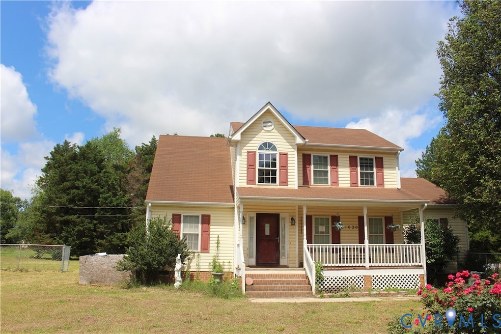 View of front of house featuring covered porch and a shingled roof