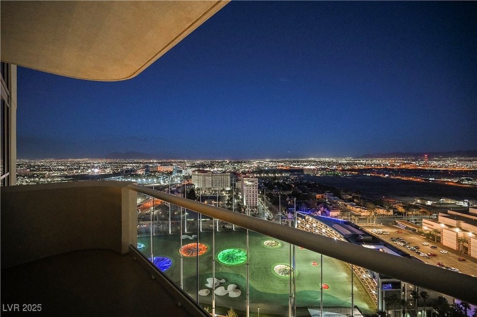 Balcony at night with a view of city lights and To