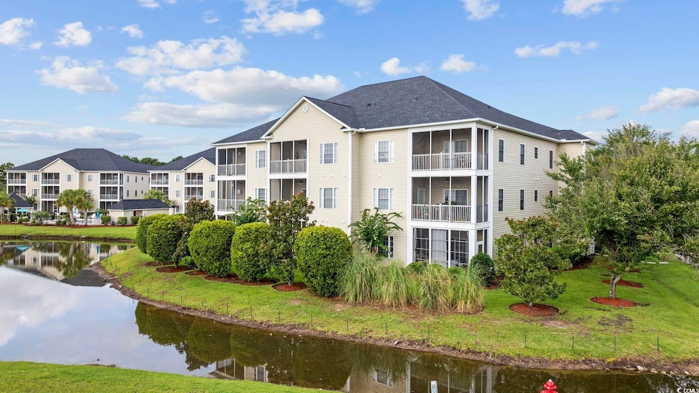 View of property with a water view