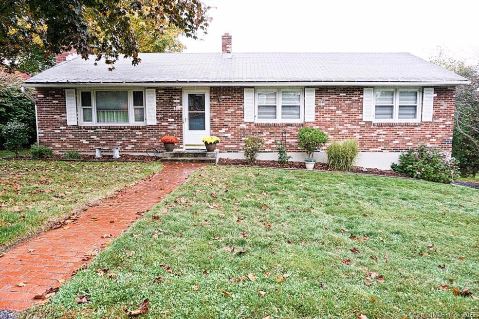 Front view shows welcoming brick walkway and nice 