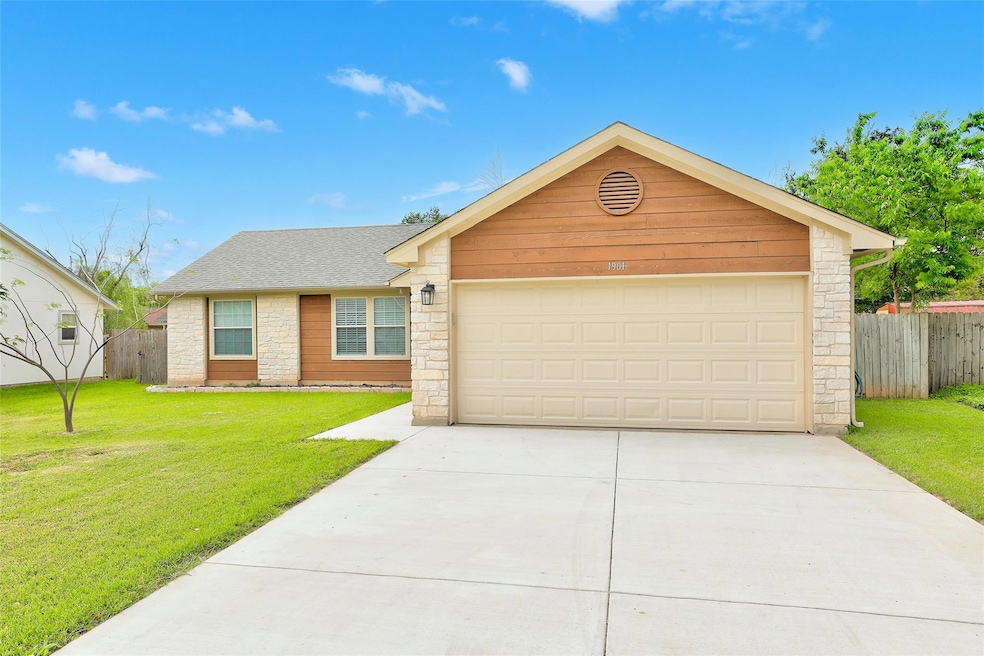Ranch-style home with a front yard, driveway, sto