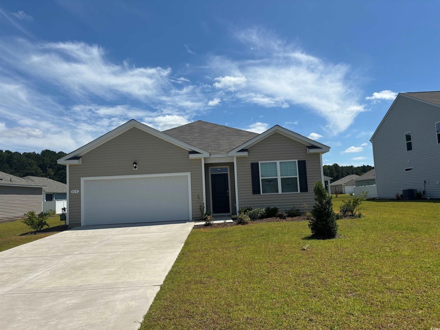 View of front of house with a garage, a front yard