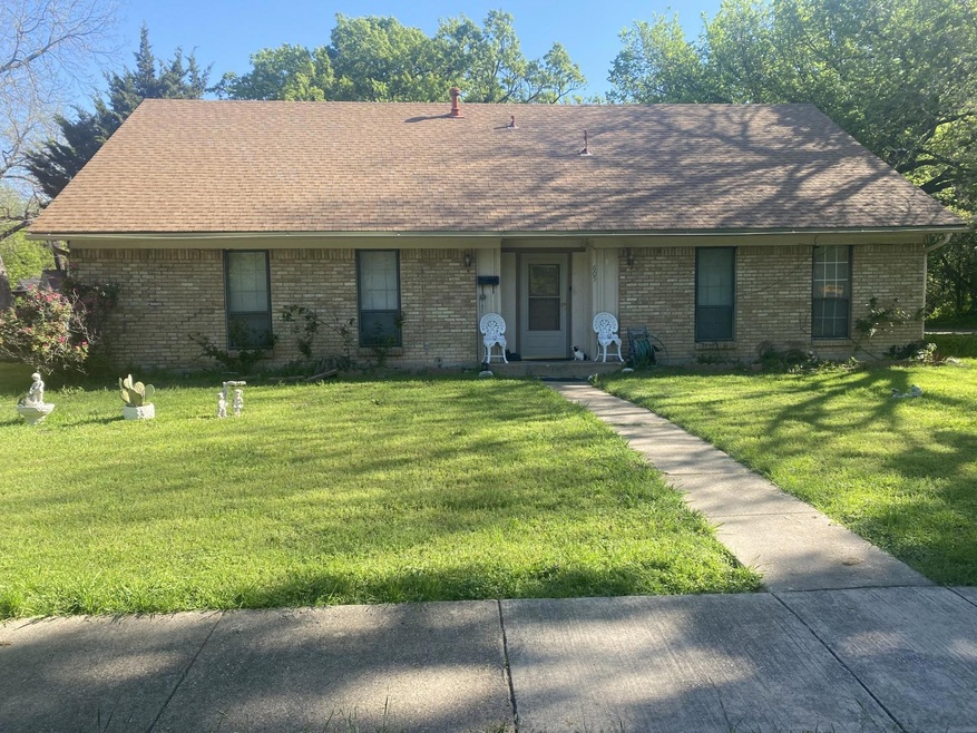 Single story home featuring a front lawn