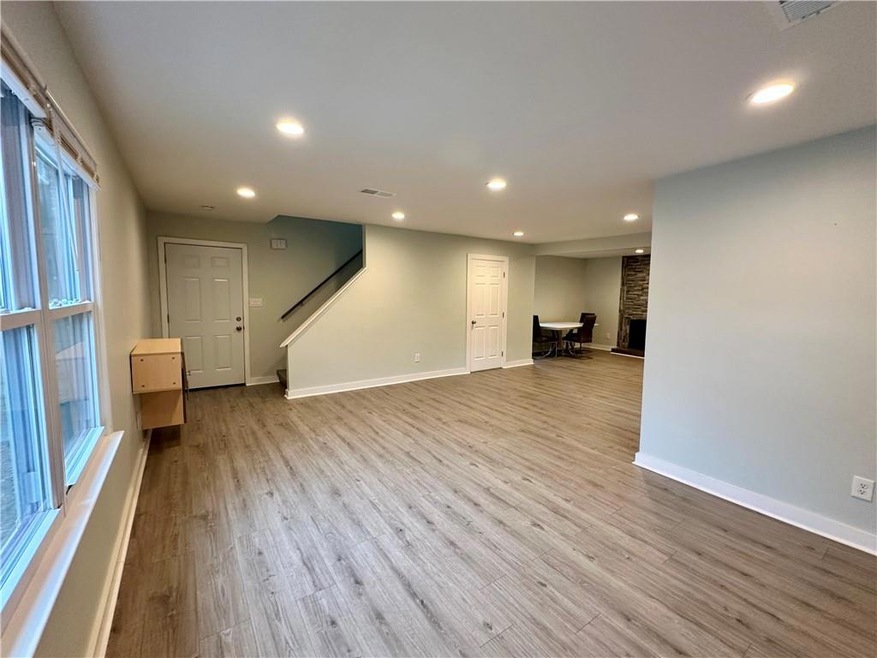 Unfurnished living room with a fireplace, light wo