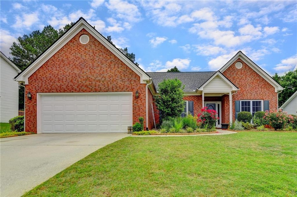 View of front of home with a garage and a front la