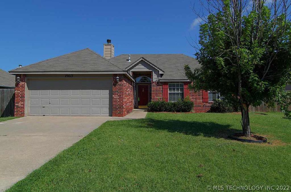 Lovely front yard with mature tree.