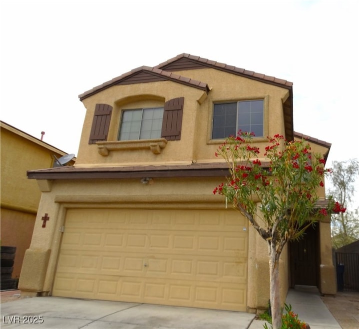 View of front of home with stucco siding, a tile r