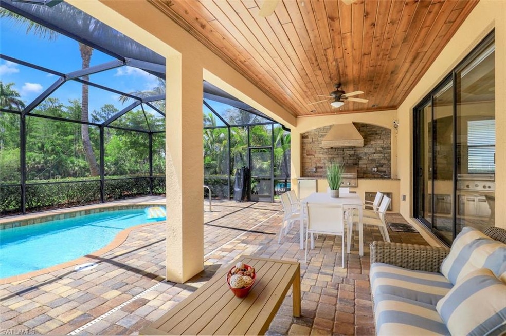 Swimming pool featuring a patio area, outdoor dining area, glass enclosure, and ceiling fan