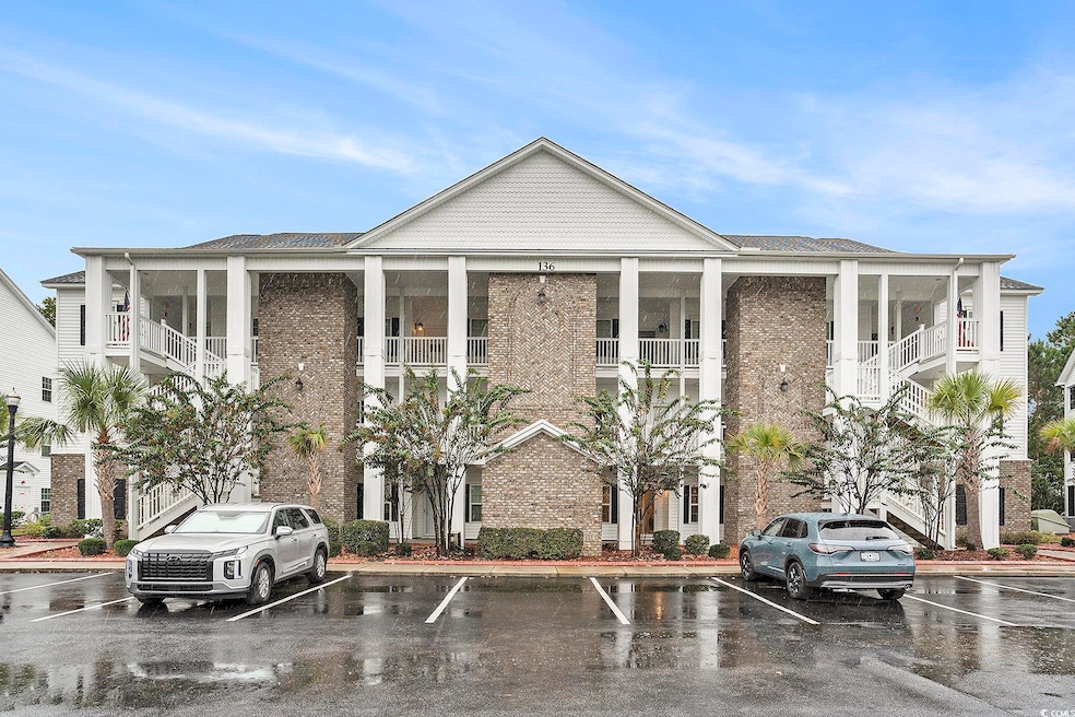 View of front of home featuring brick siding and uncovered parking