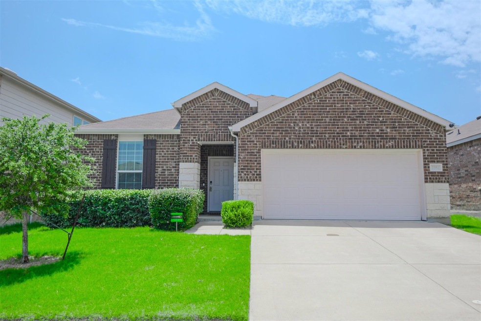 View of front of home with a garage and a front la
