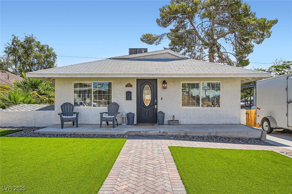 View of front of property with a front yard, stucc