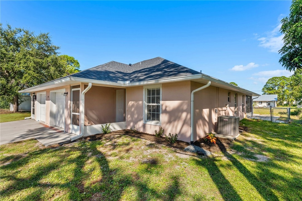 View of home's exterior with stucco siding, a gate, a garage, and concrete driveway