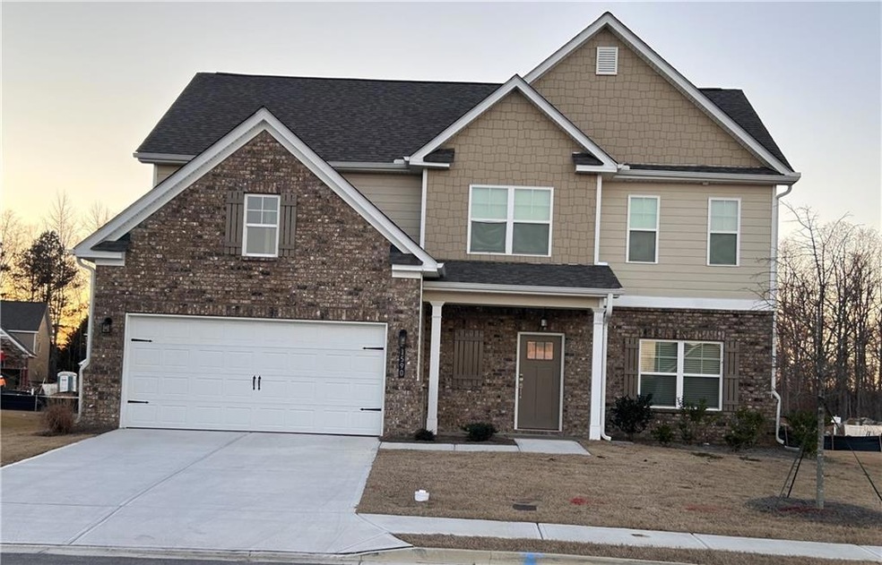 Craftsman-style house with brick siding, driveway, an attached garage, and roof with shingles