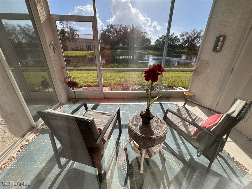 Sunroom featuring a water view