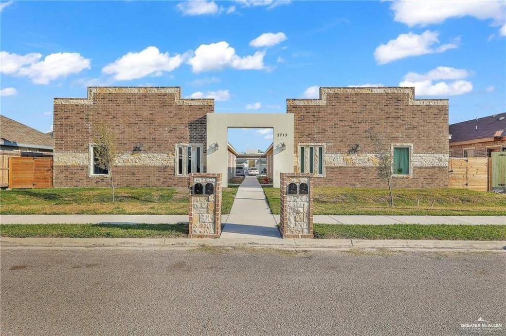 View of front of property featuring a front yard, fence, and brick siding