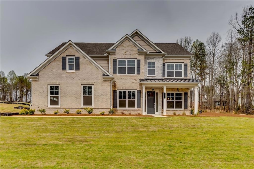 Craftsman-style house featuring a front yard, bric