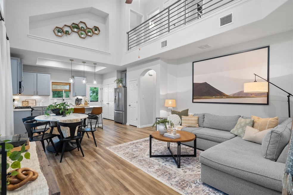 Living room with light wood-type flooring, arched